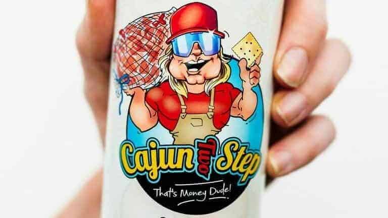 Cajun seasoning container with cartoon chef holding a fish and cheese, Louisiana-themed.
