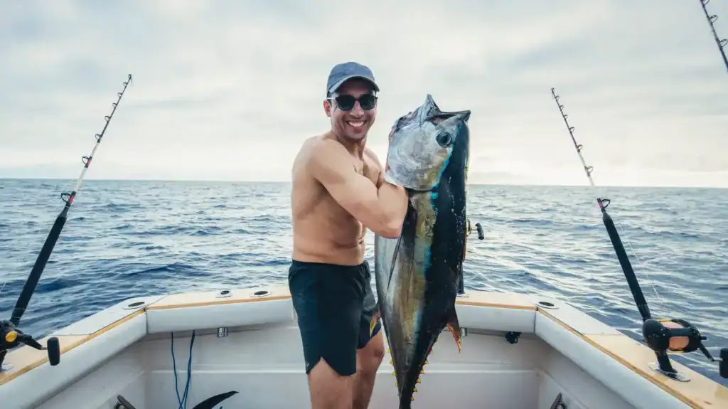 Man holding a large fish on a boat in Louisiana waters.
