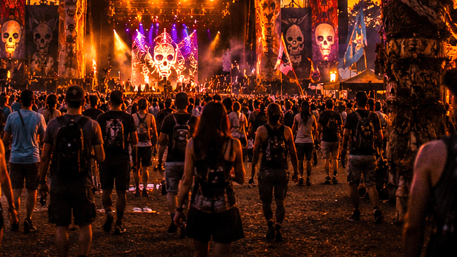 Voodoo Music Experience festival stage at sunset with crowd in Louisiana.