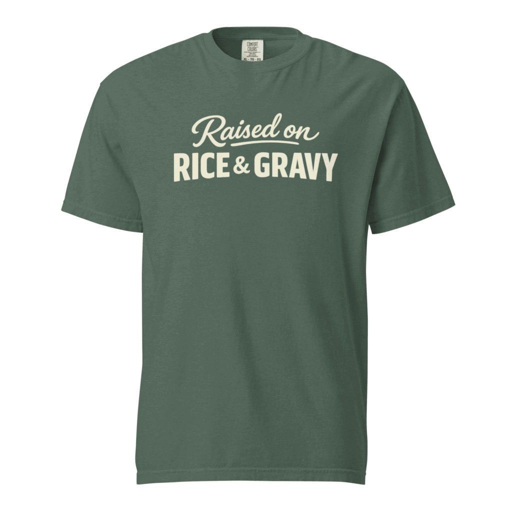 Green T-shirt with 'Raised on Rice & Gravy' slogan, Louisiana Cajun food pride.