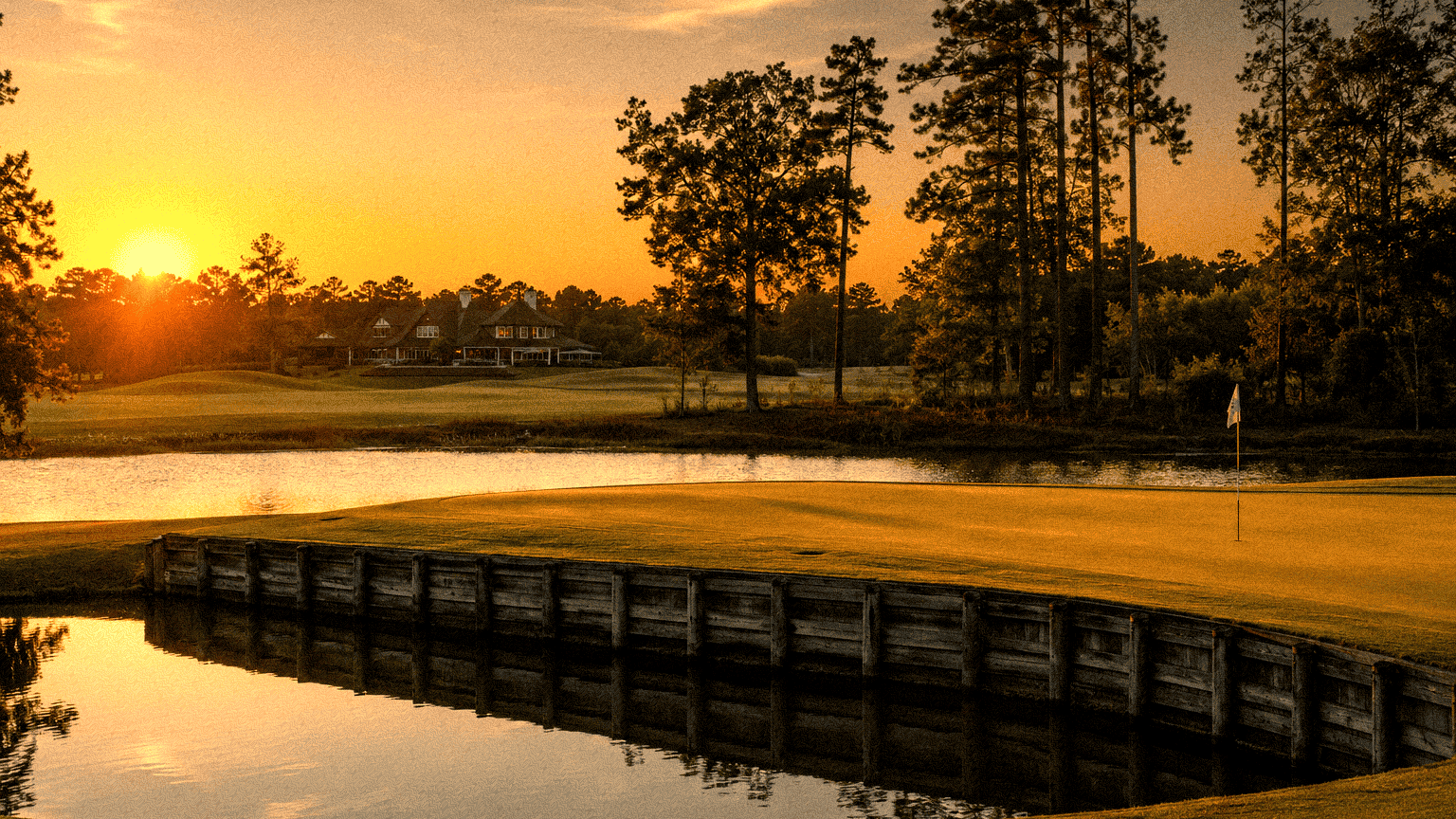 Louisiana golf course at sunset with water hazard and trees.